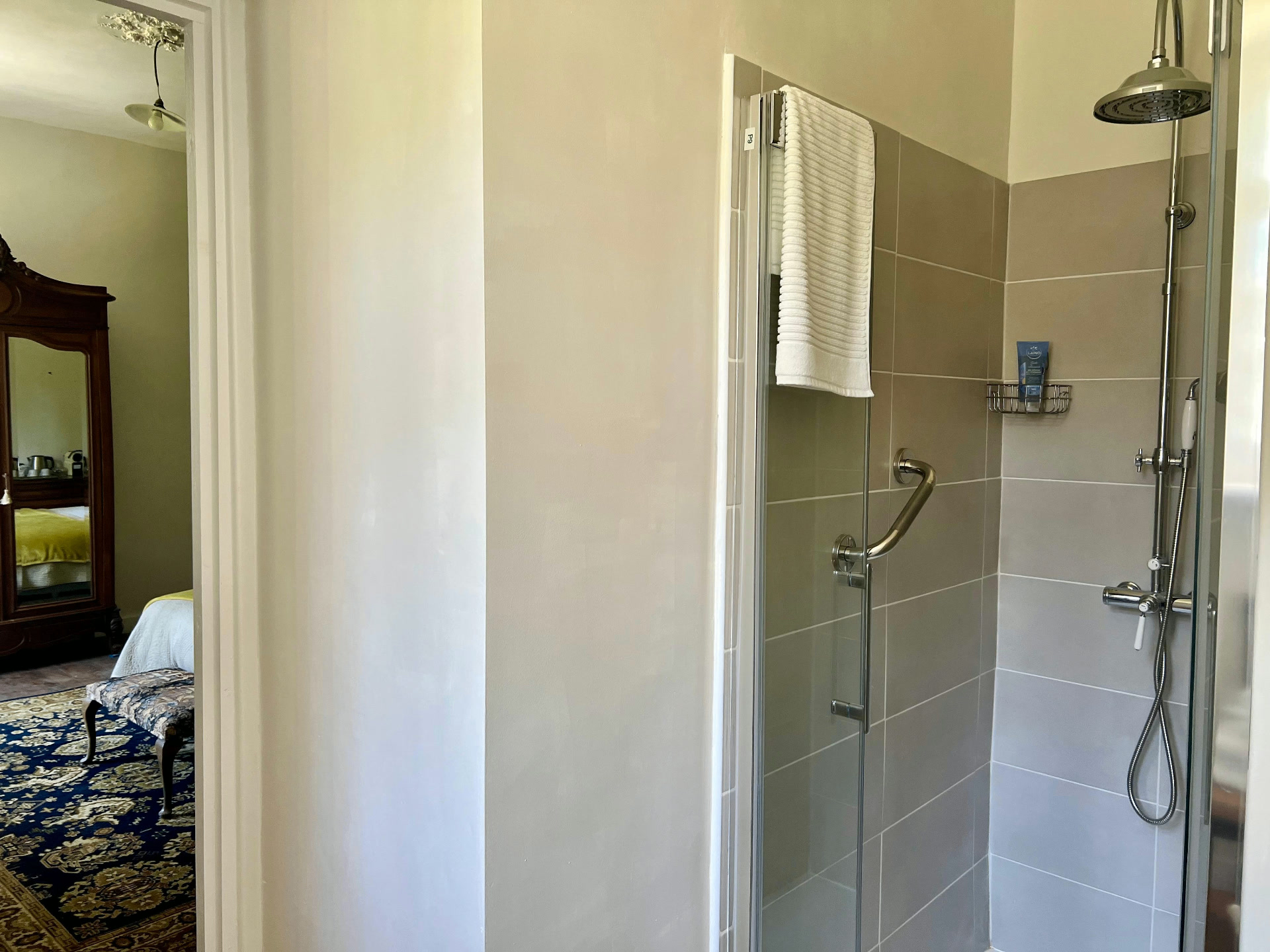 La Chambre Palerme — en-suite shower with chrome fittings and bedroom view