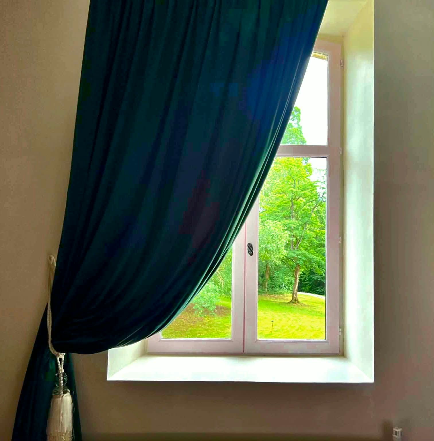 La Chambre Valadon — garden view through draped window